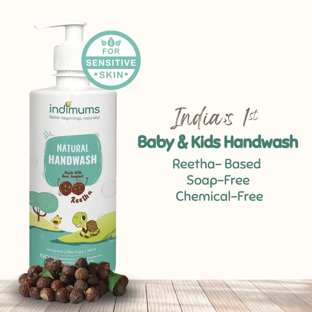 Indimums Natural Baby and Kids Handwash bottle with reetha on a wooden surface, featuring text highlighting reetha-based, soap-free, and chemical-free formula
