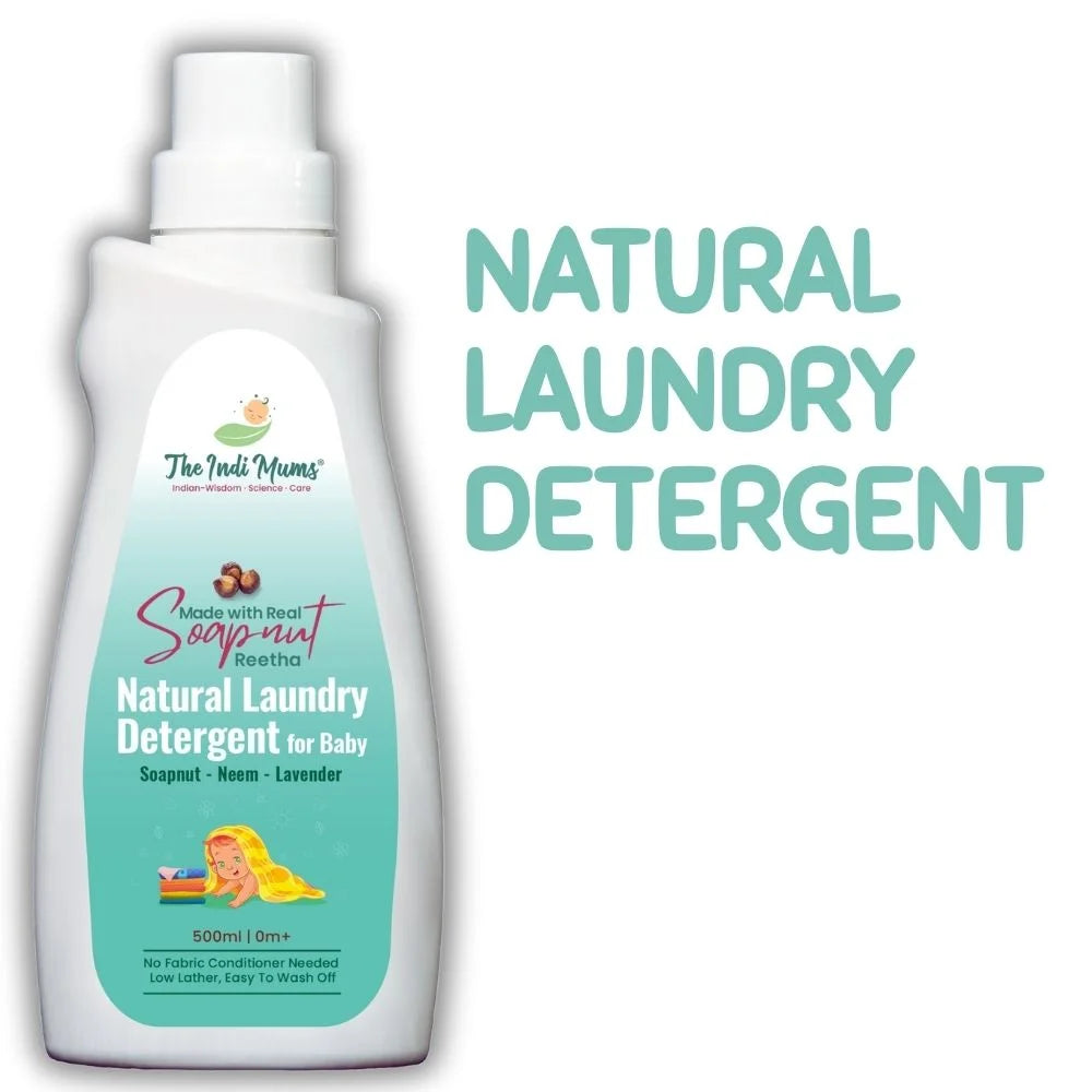 A white plastic bottle of "The Indi Mums Natural Laundry Detergent for Baby" with teal-colored liquid visible through the transparent bottom half. The bottle features the brand logo and text indicating it's made with real soapnut (Reetha) and contains soapnut, neem, and lavender. The label shows it's 500ml, suitable for 0+ months, requires no fabric conditioner, and is low lather and easy to wash off. A cartoon illustration of a child is visible on the label.
