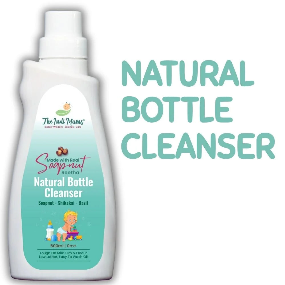 White bottle of "The Indi Mums" Natural Bottle Cleanser with teal label featuring soapnut, shikakai, and basil ingredients. The 500ml bottle has a pump dispenser and shows cartoon illustration of a child with toys. Text highlights it's tough on milk film and odour, low lather, and easy to wash off.