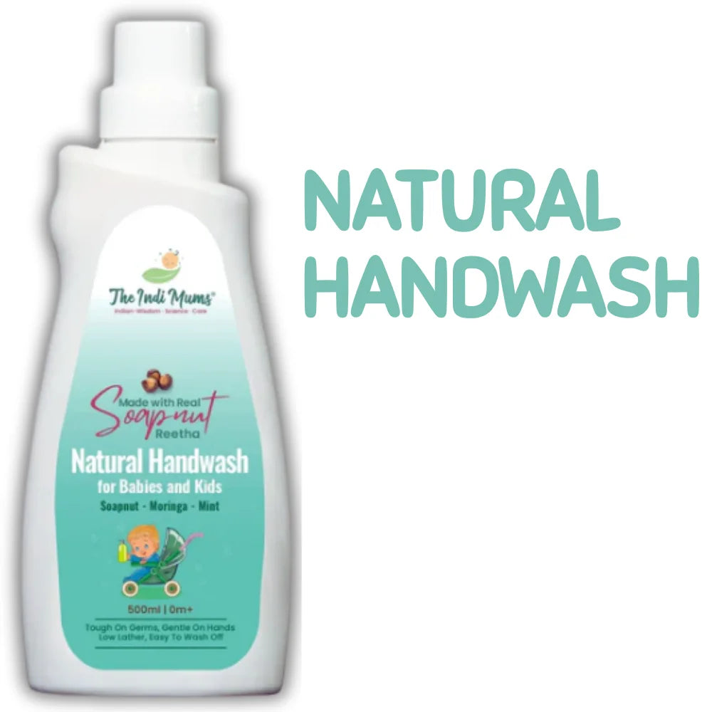 A white bottle of "The Indi Mums Natural Handwash for Babies and Kids" with a teal-colored label featuring soapnut, moringa, and mint ingredients. The 500ml bottle shows "Tough On Germs, Gentle On Hands" and includes a cartoon illustration of a child with a toy wagon.
