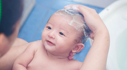 Is it safe to use regular baby shampoo when bathing a newborn?