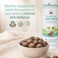 Indimums natural baby body wash with a bowl of Reetha fruits on a light background