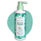 The Indi Mums Natural Baby Shampoo, a 200ml bottle with a pump dispenser, sits beside two pink baby hairbrushes. The shampoo is made with Shikakai and Flaxseed Oil, and is free of parabens, sulphates, artificial colors, and fragrances.
