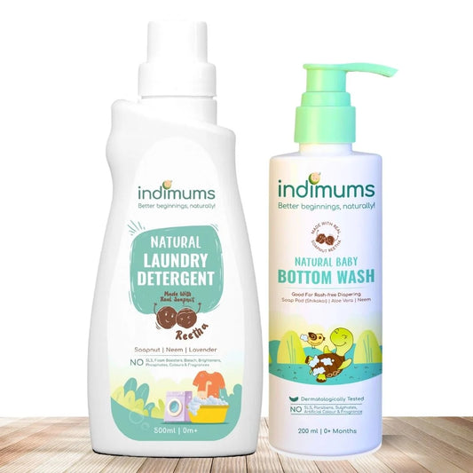 Two bottles of Indimums Natural Laundry Detergent & Bottom Wash on a wooden surface with a white background