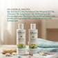 Two bottles of Indimums natural baby shampoo & baby body wash on a wooden surface with a towel and bath items in the background.