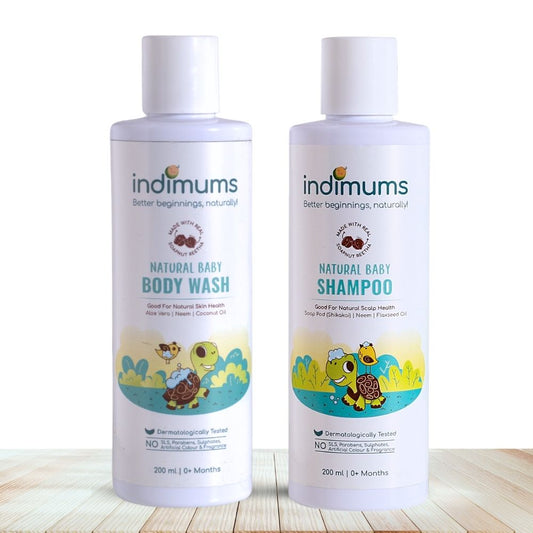 Two bottles of Indimums Natural Baby Shampoo and Body Wash on a wooden surface with a white background