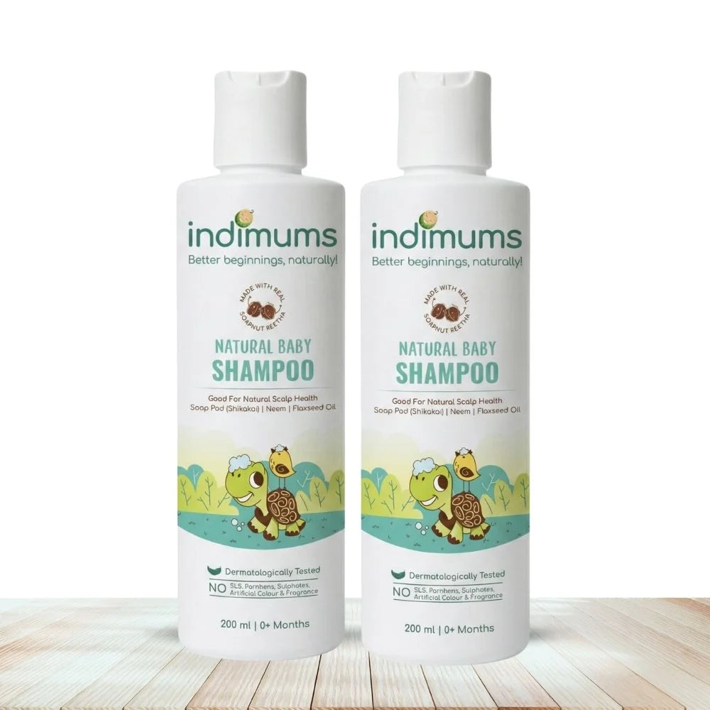 Two bottles of indimums natural baby shampoo on a wooden surface with a white background