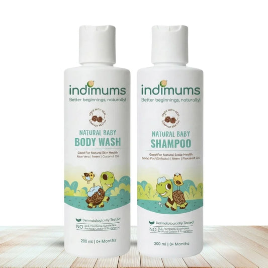 Two bottles of Indimums Natural Baby Shampoo and Body Wash on a wooden surface with a white background