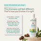 A bottle of indimums Natural Baby Shampoo displayed on a light beige background with informational text on the left and decorative acorns and leaves on a stone slab at the bottom right.