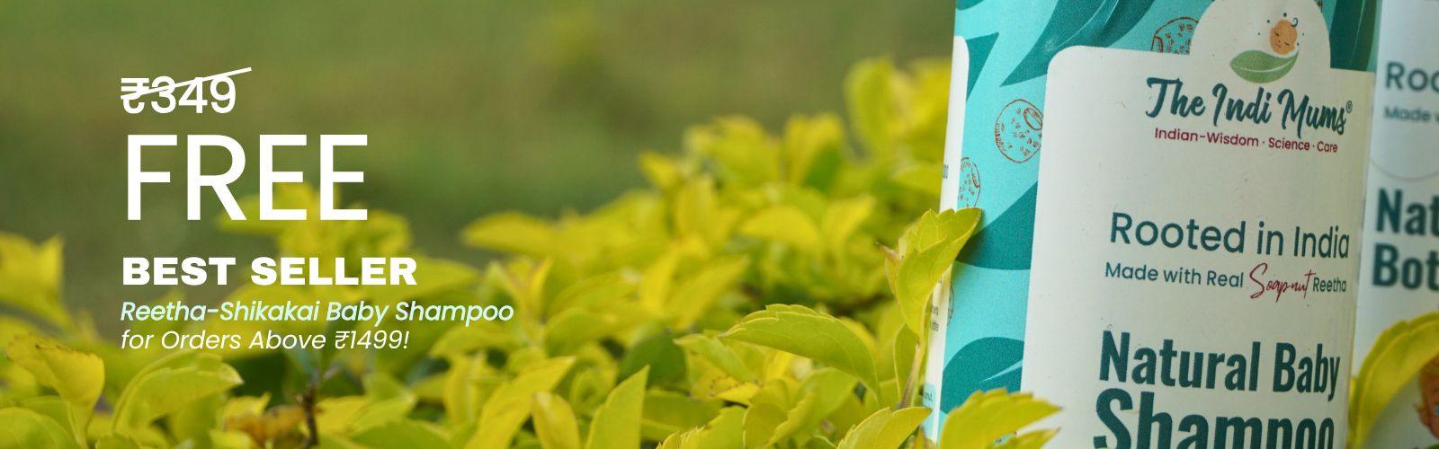 A natural baby shampoo bottle with a pump dispenser, surrounded by greenery.