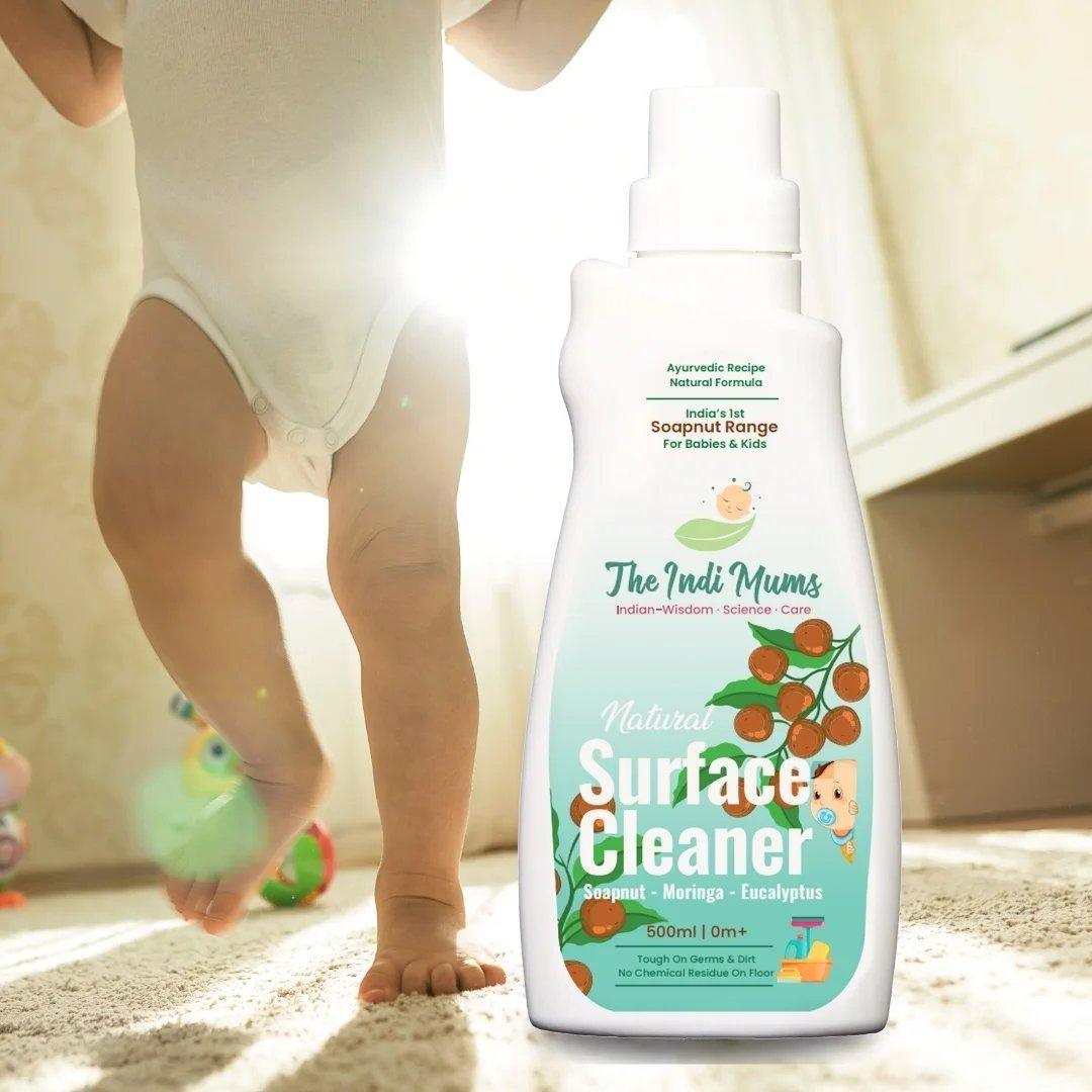 A bottle of The Indi Mums Natural Surface Cleaner, highlighting its natural ingredients like soapnut, moringa, and eucalyptus, and its effectiveness in removing germs and dirt without leaving any chemical residue.

